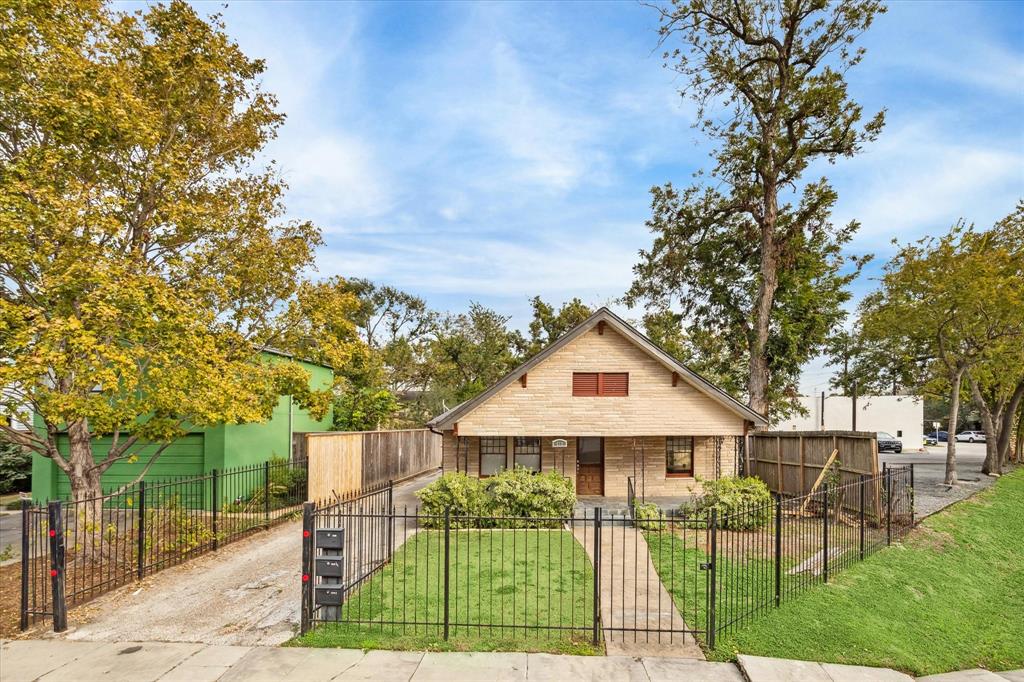 a view of house with outdoor seating and yard