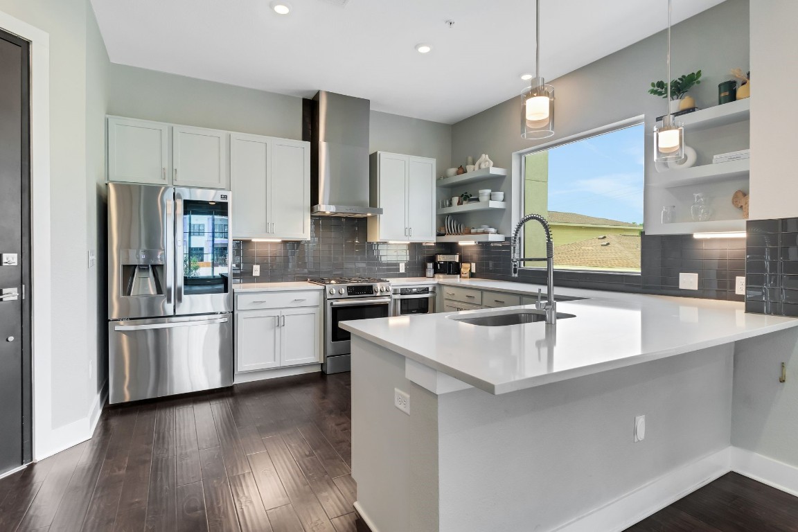 a kitchen with a sink stove and refrigerator