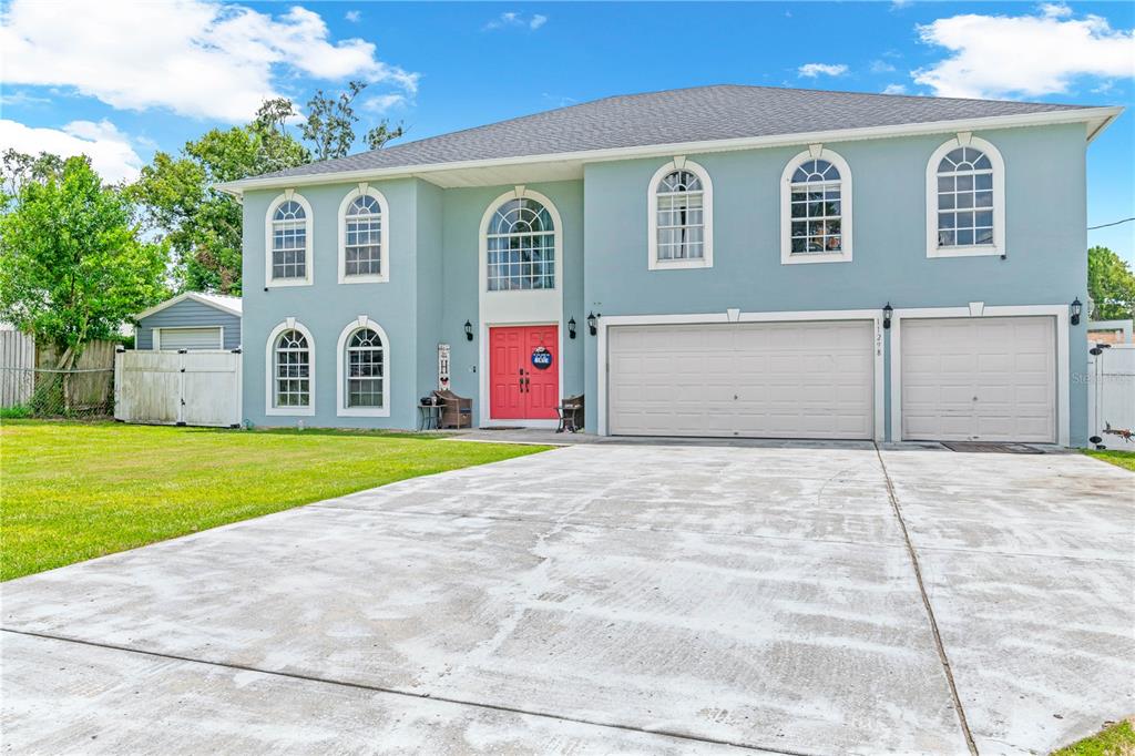 a view of a house with a yard and garage