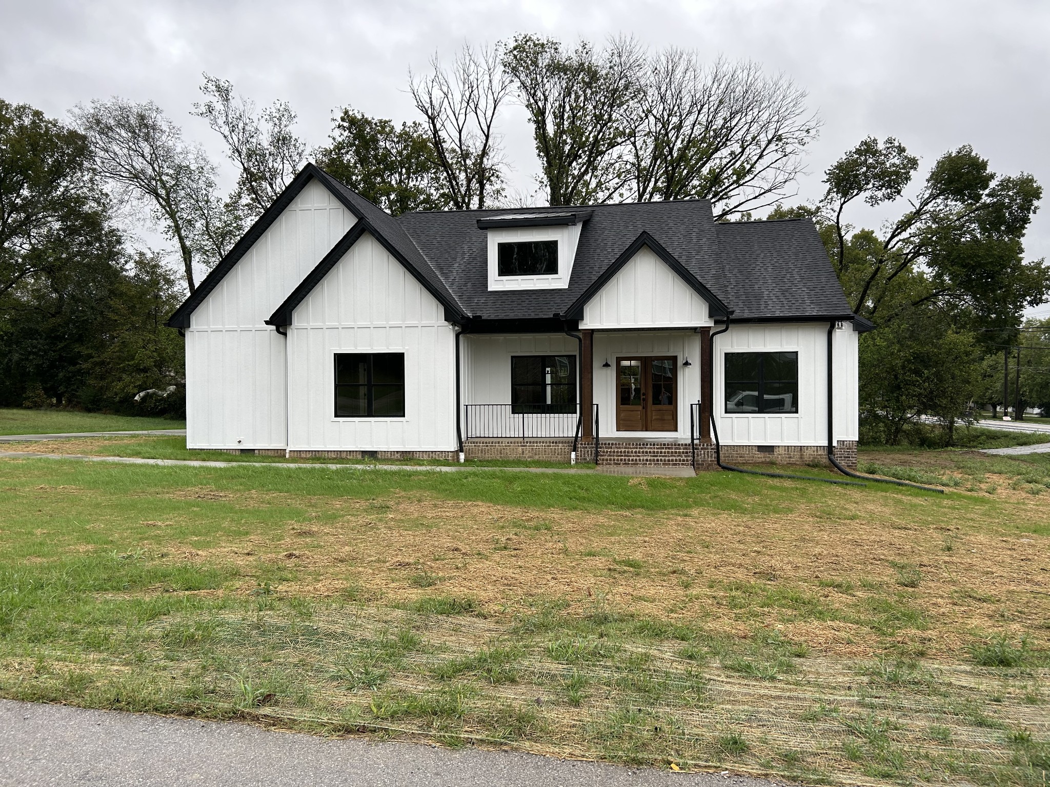 a front view of a house with a garden