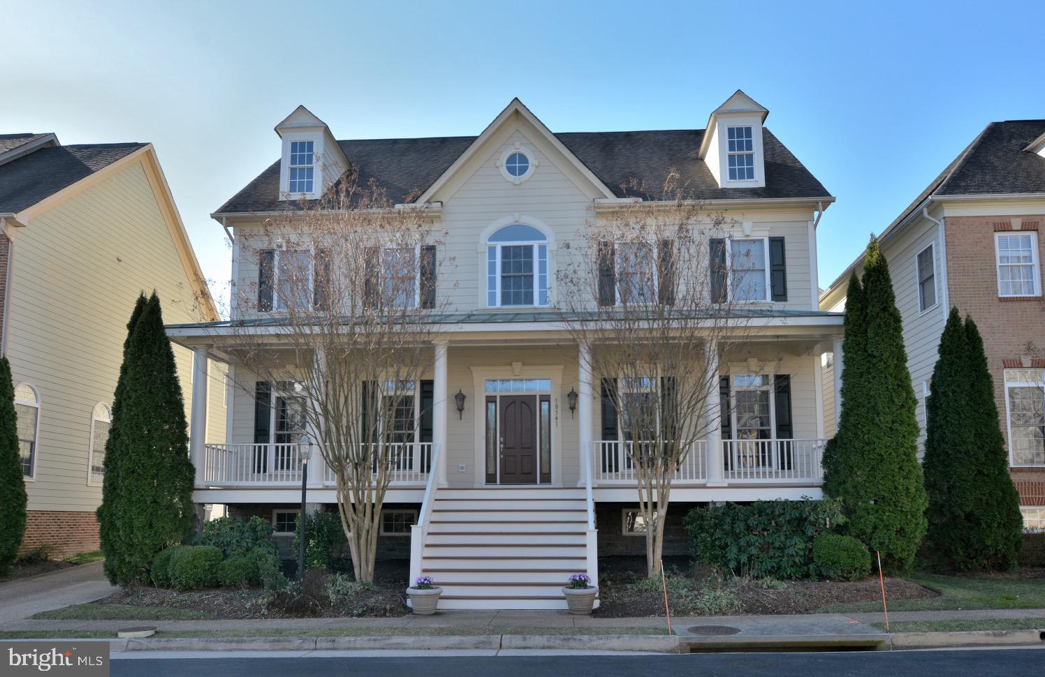 a view of a white house with a clock on the walls