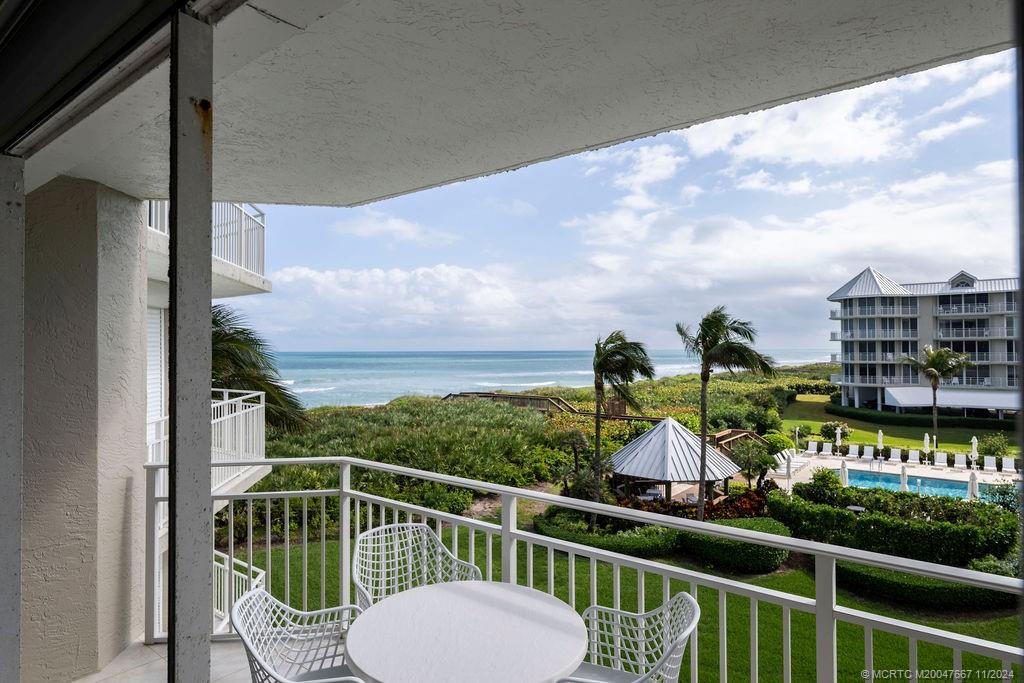 a view of a chairs and table in the balcony