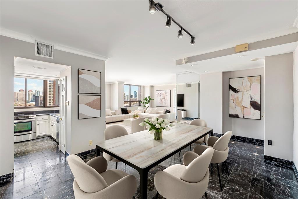 Dining room looking towards the open living area. Image shown virtually staged.