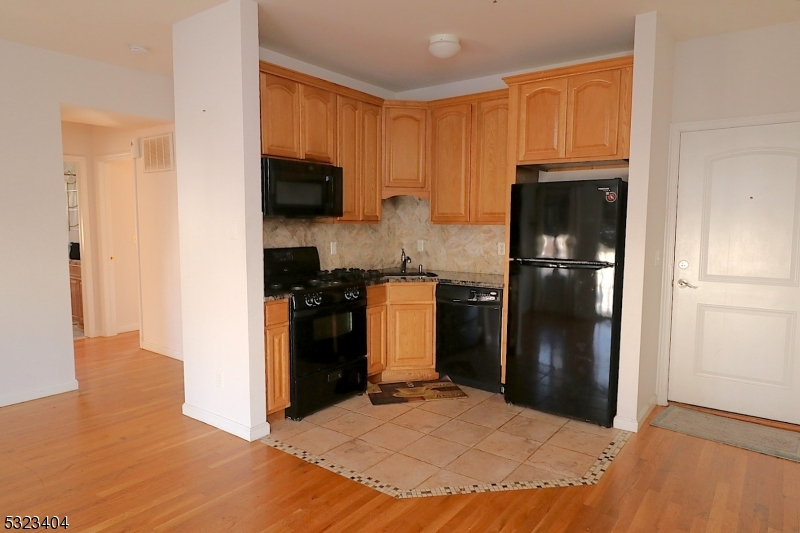 a kitchen with a refrigerator and a stove