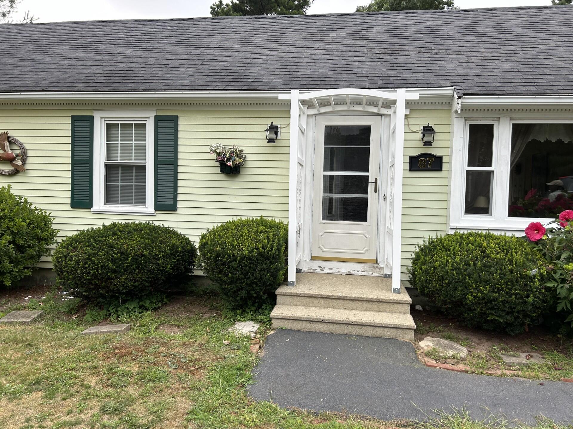 a front view of a house with a garden