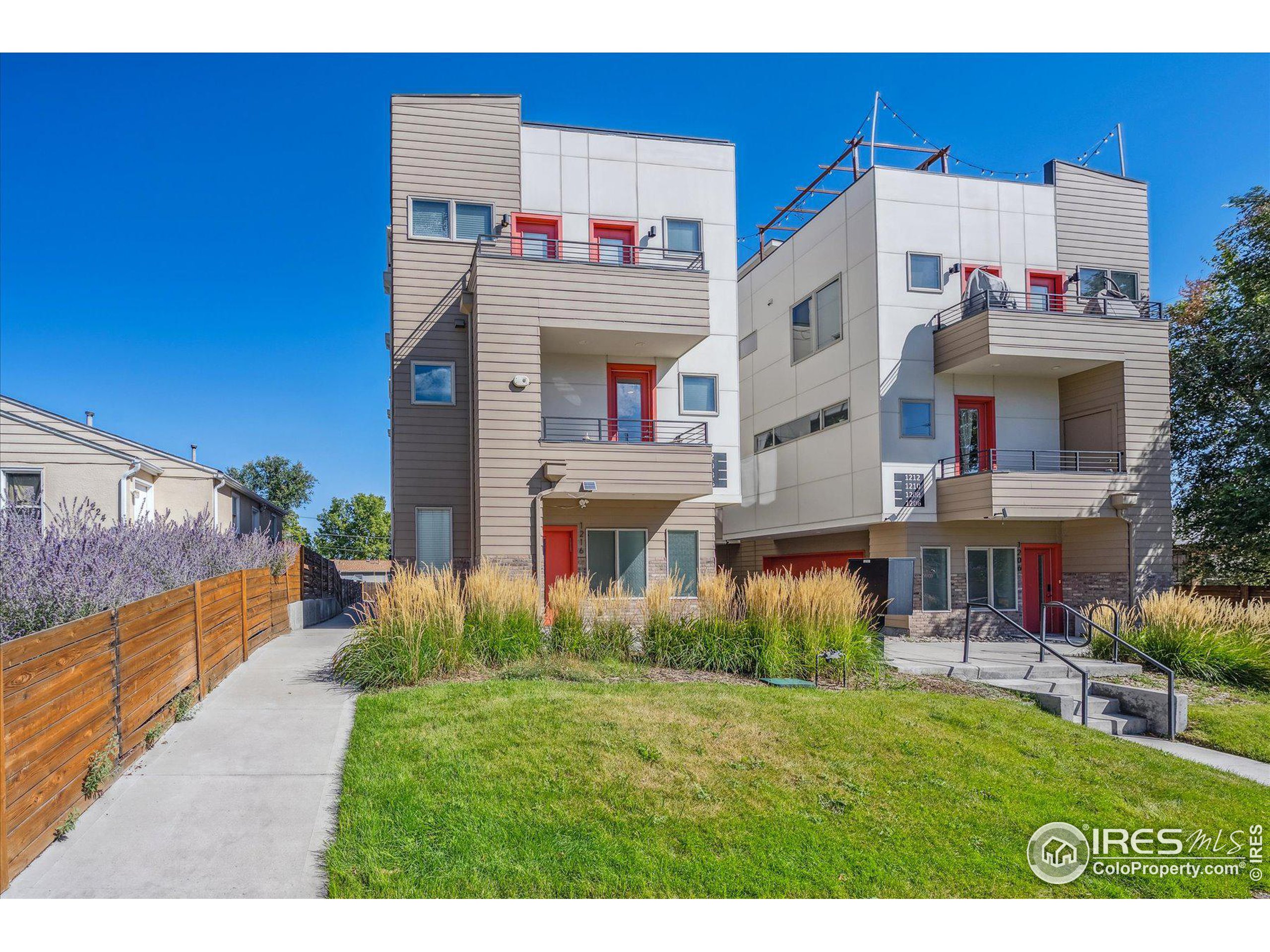 a front view of a residential apartment building with a yard