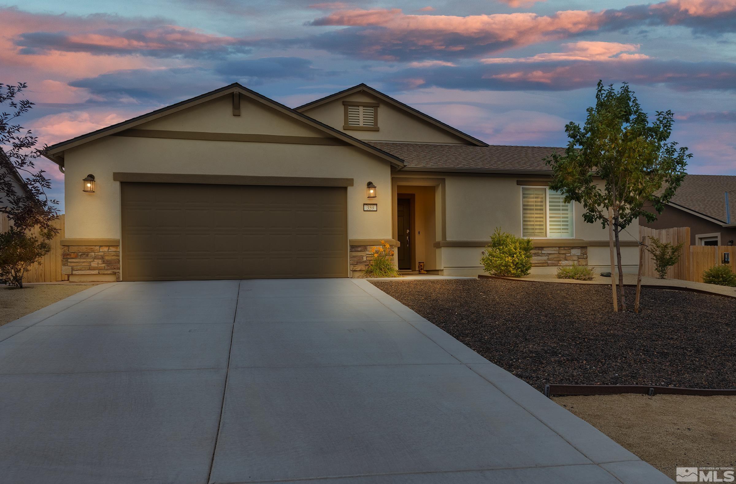 a front view of a house with garage