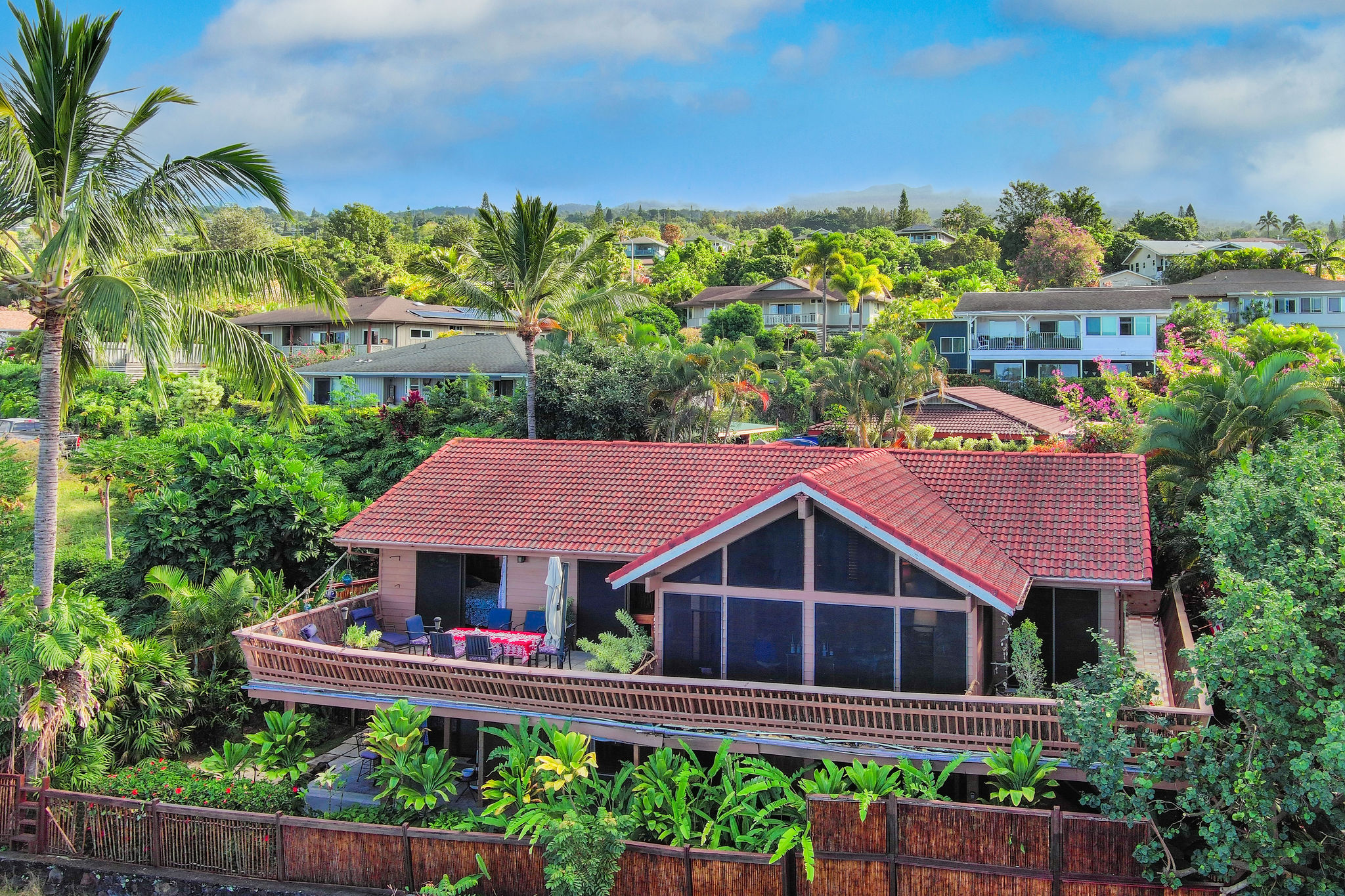 a view of a house with a yard and potted plants