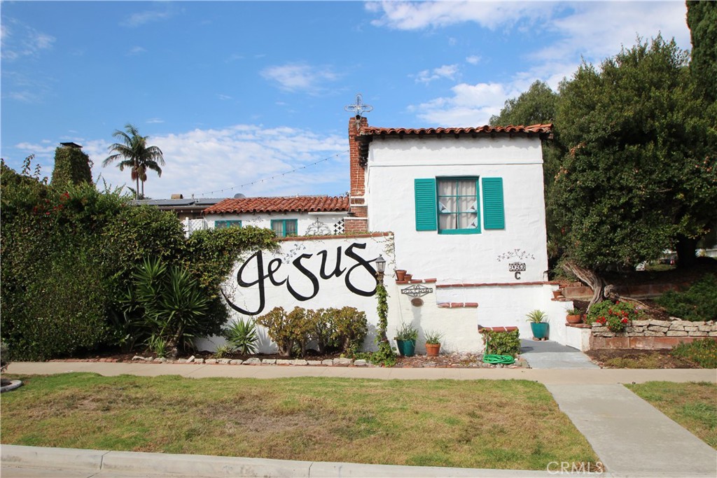 a front view of a house with garden