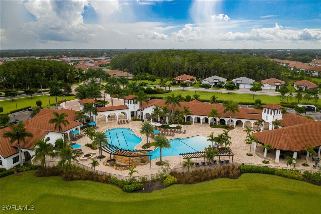 an aerial view of a house with a garden and lake view