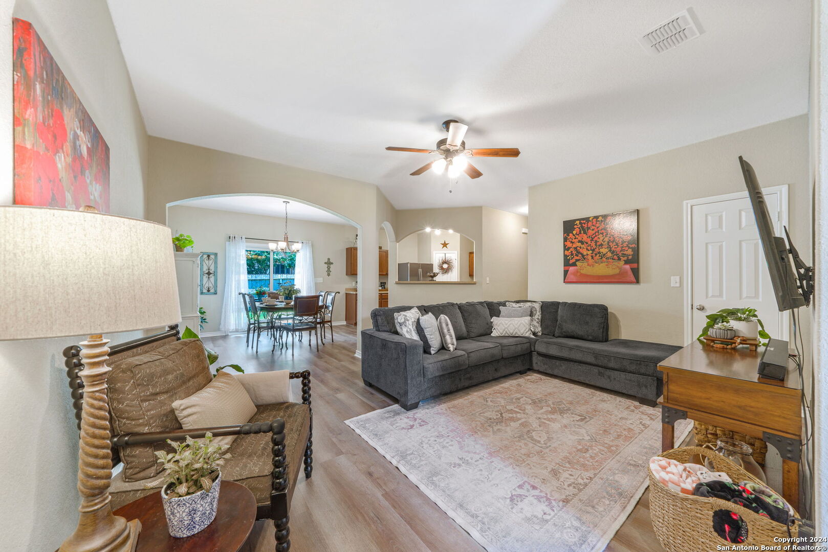 a living room with furniture and wooden floor