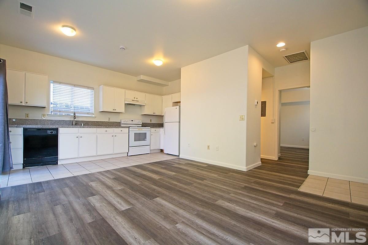 a kitchen with stainless steel appliances granite countertop a stove and a refrigerator