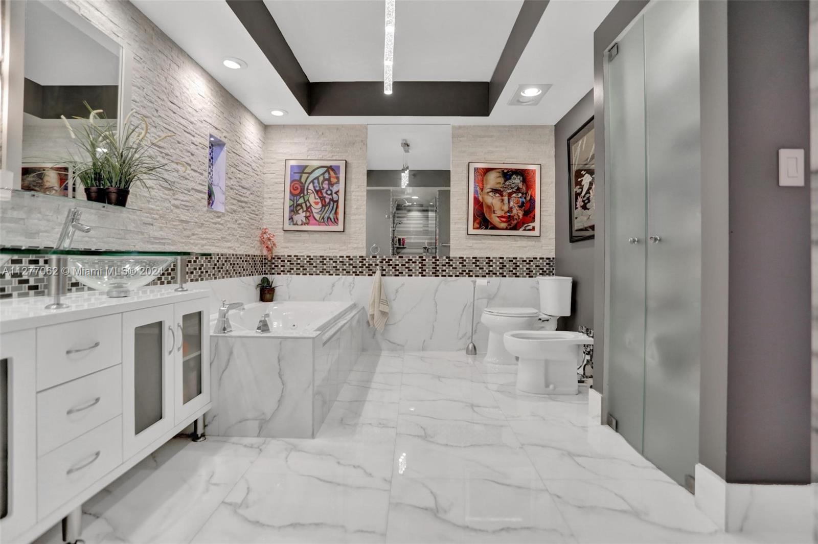 a bathroom with a sink a vanity and bathtub