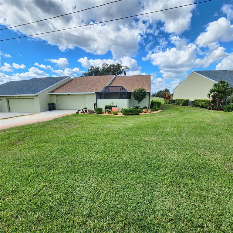 a view of a big yard with a house in the background