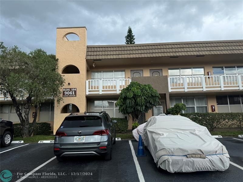 a view of a car park in front of house