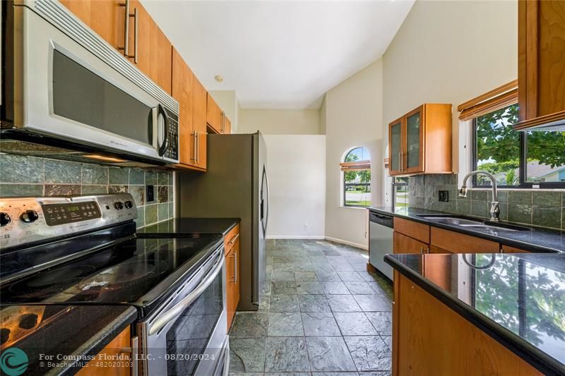 a kitchen with stainless steel appliances granite countertop a stove and a sink