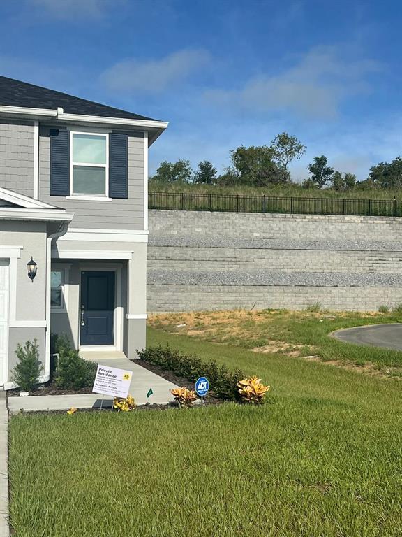 a view of a house with a yard and a swimming pool