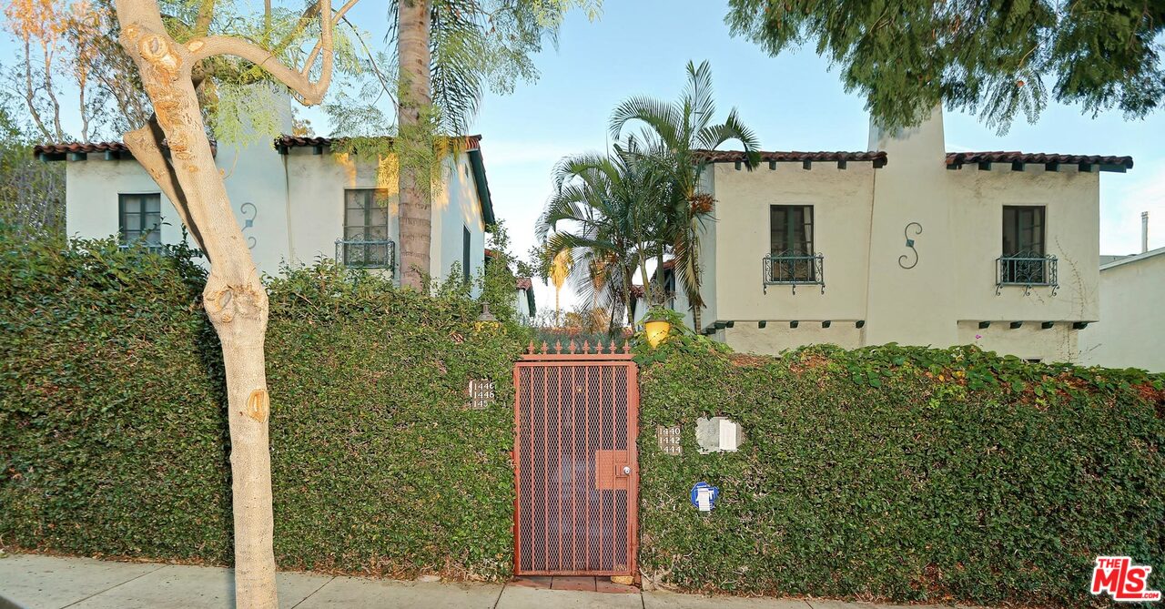 a view of a house with a tree in the background