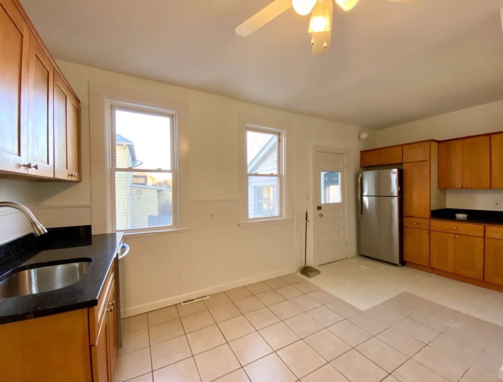 a view of a kitchen with a refrigerator cabinets and a window