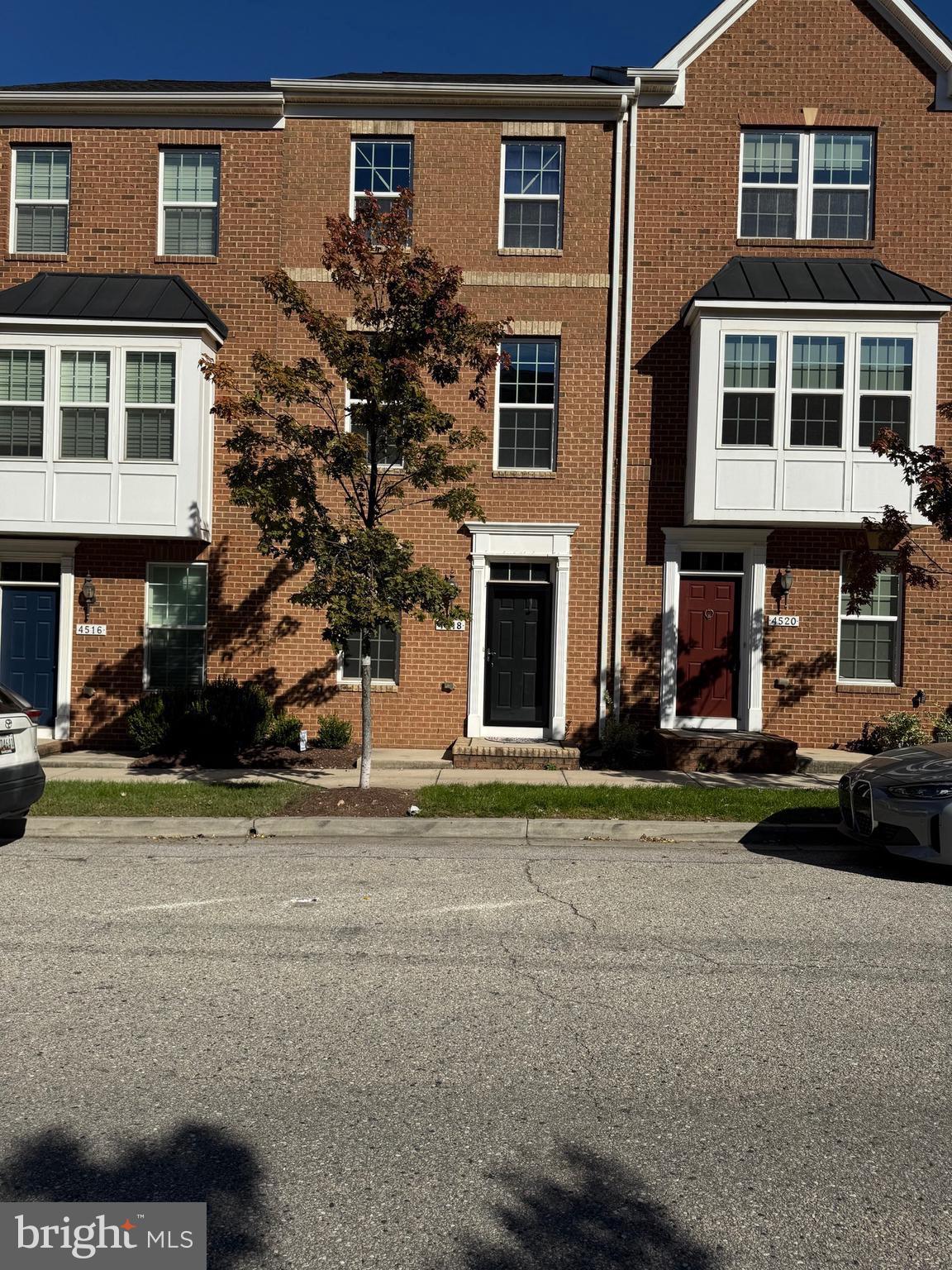 a front view of a residential apartment building with a yard