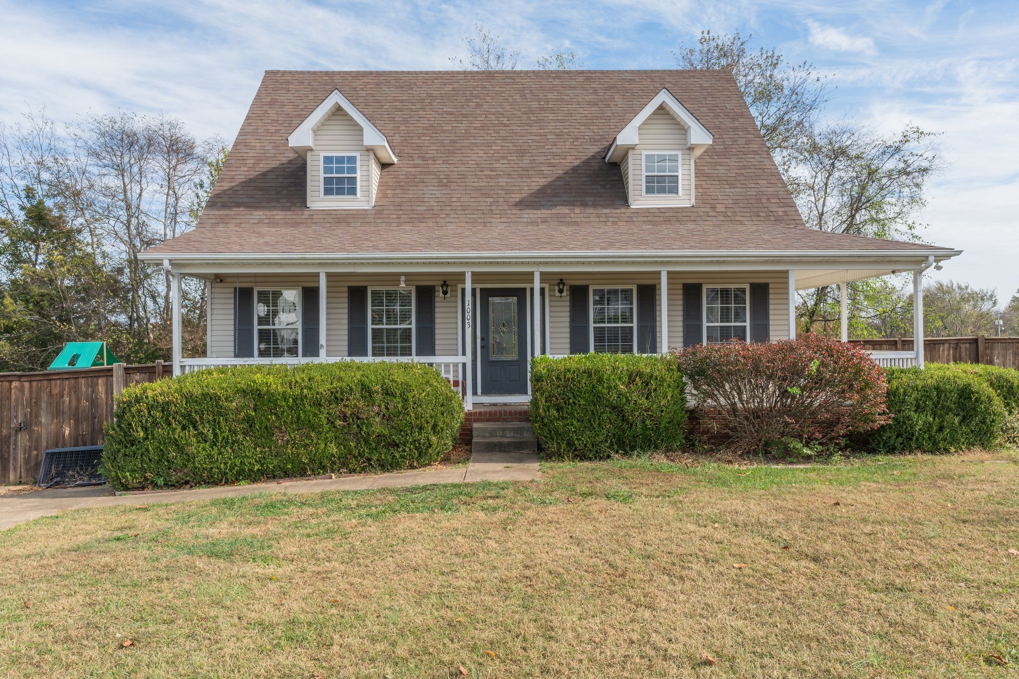 a front view of a house with garden