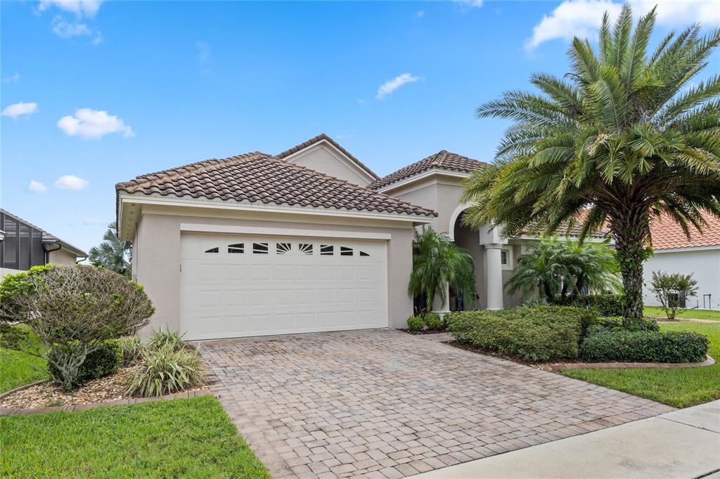 a front view of a house with a garage and a yard