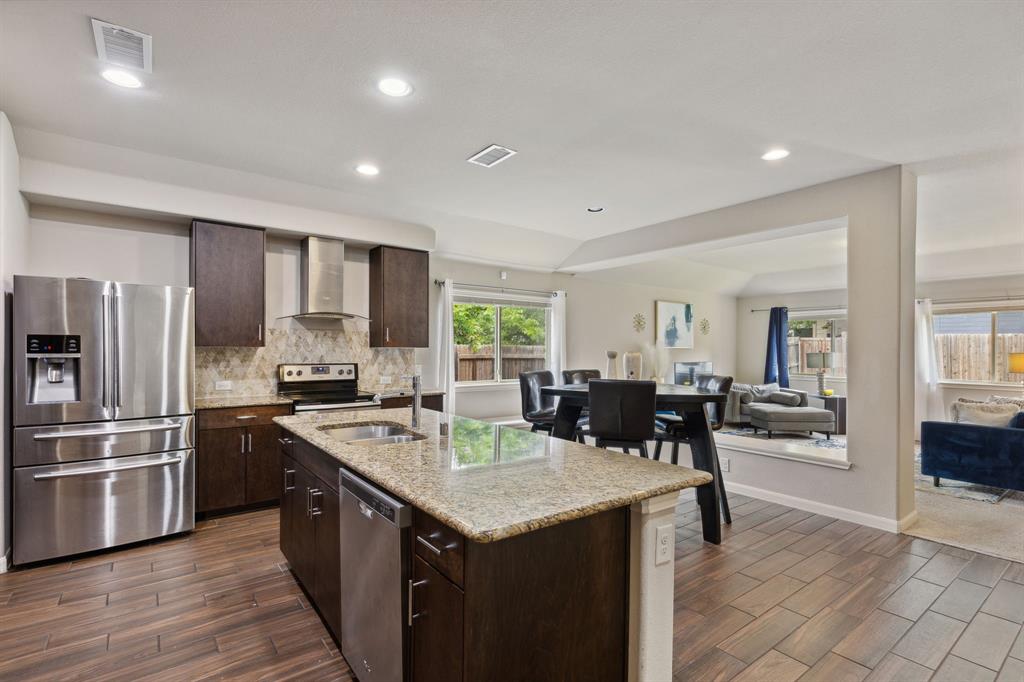 a kitchen with a sink a counter top stainless steel appliances and cabinets