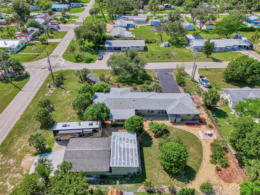 an aerial view of a house with garden space and street view