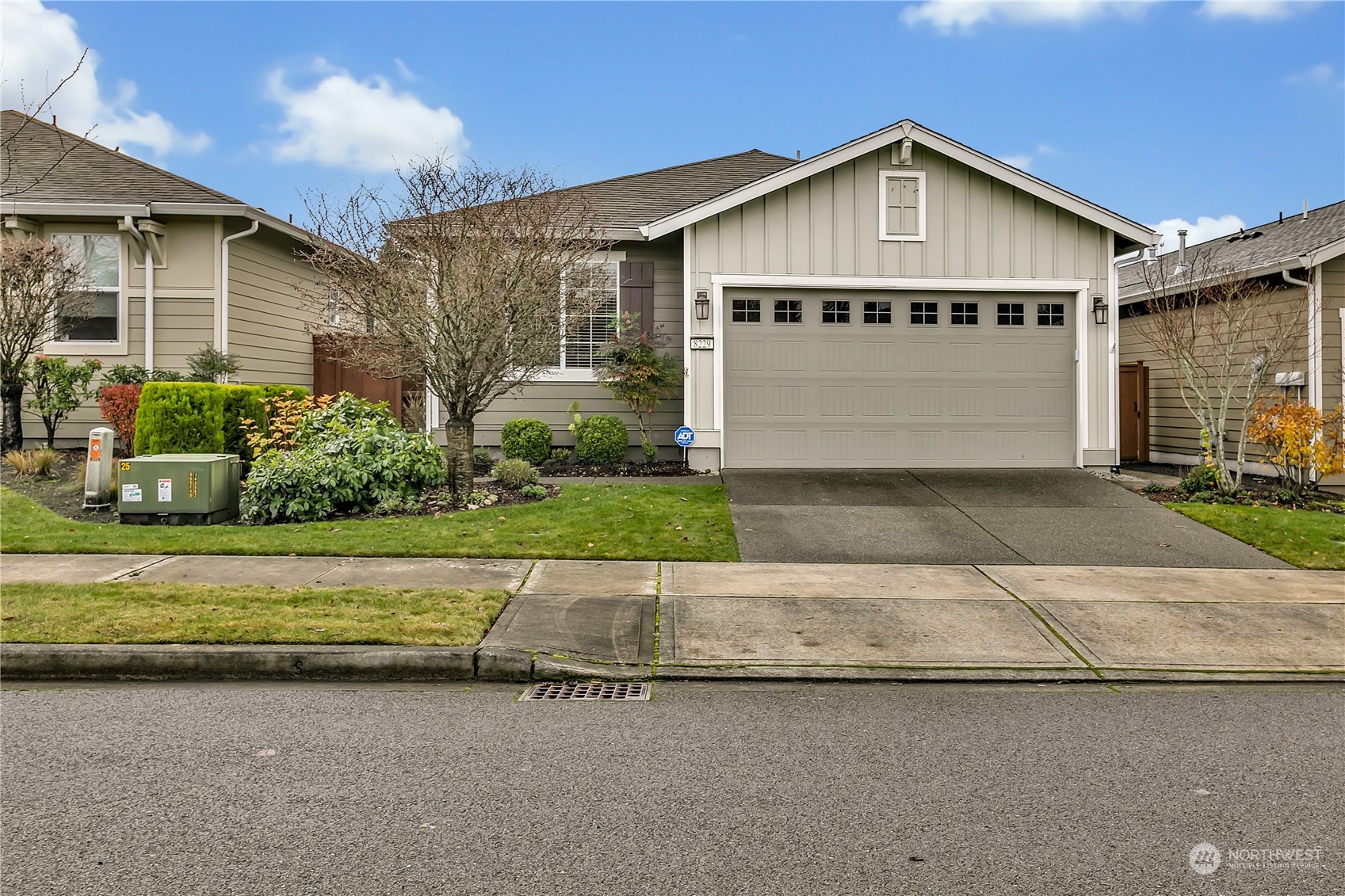 a front view of a house with a yard and garage