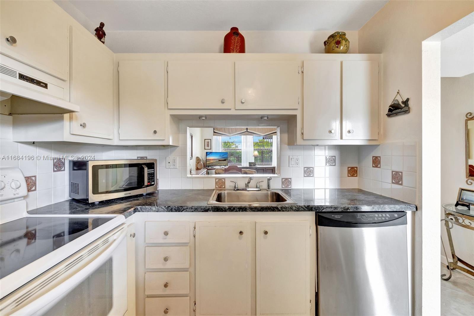 a kitchen with stainless steel appliances granite countertop a refrigerator sink and cabinets