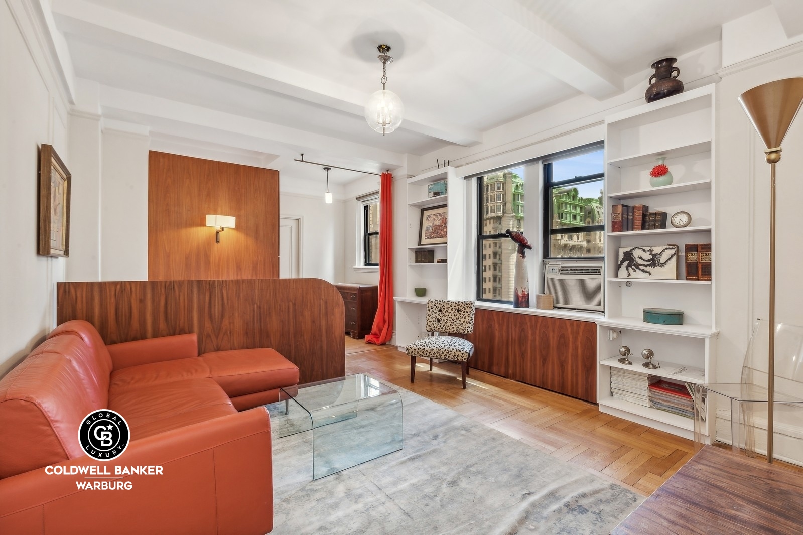 a living room with furniture cabinets and window