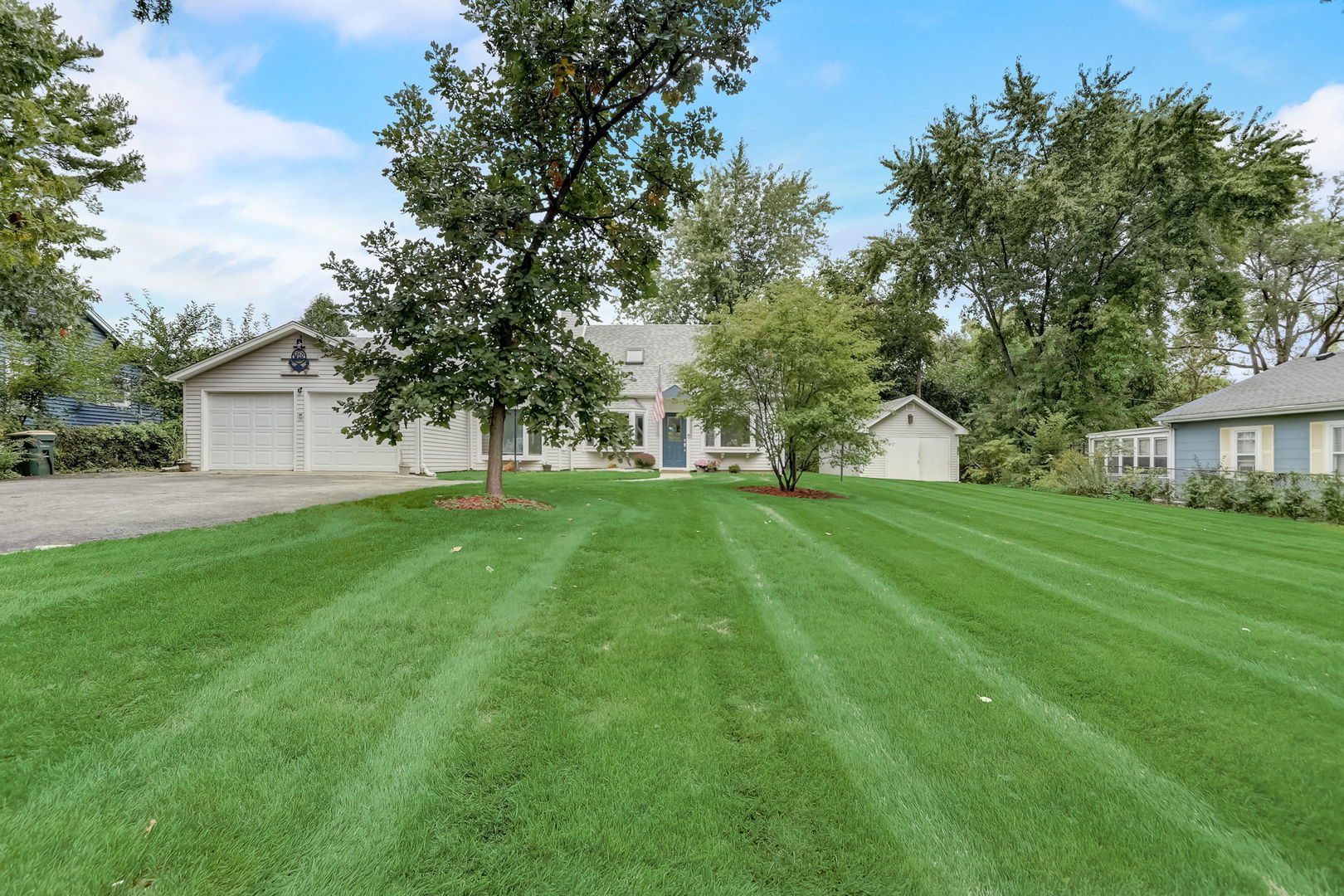 a view of house with backyard space and garden