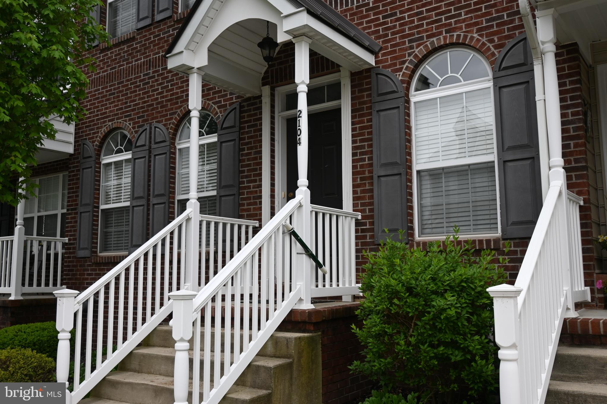 a view of a house with large windows and a small yard