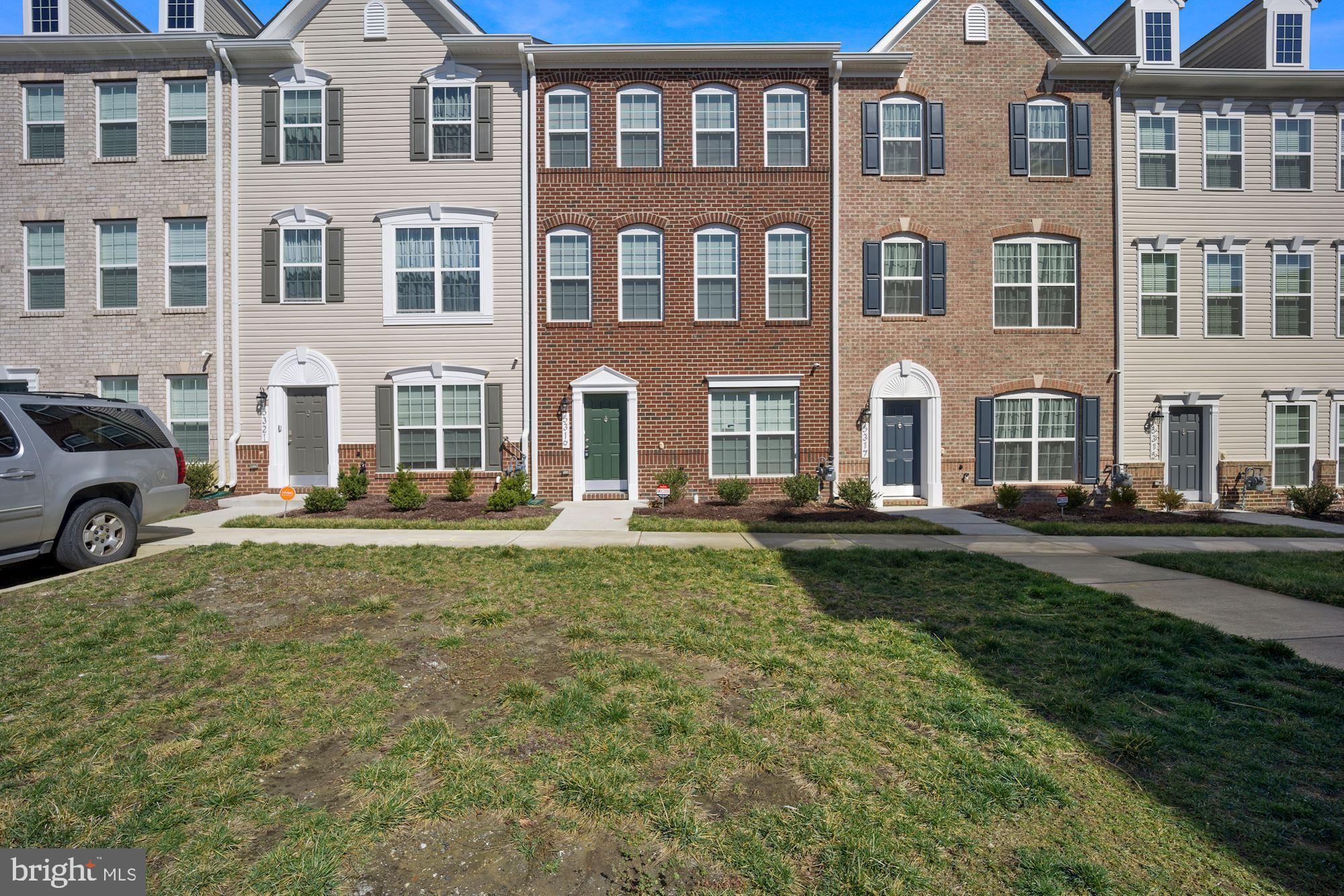 a front view of a residential apartment building with a yard