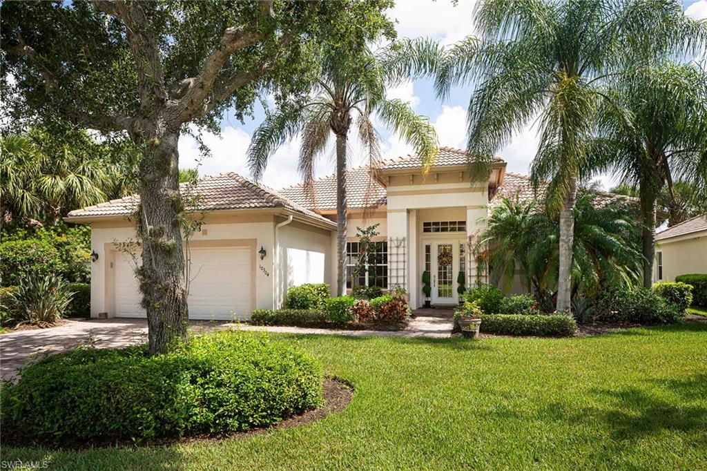 a front view of house with yard and green space