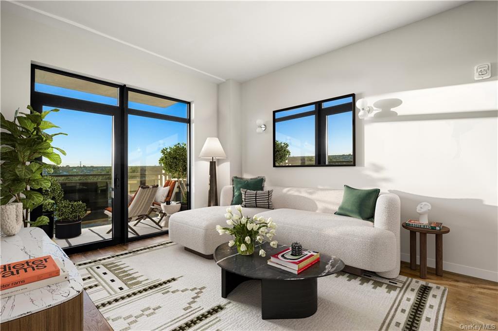 a living room with furniture potted plant and a window