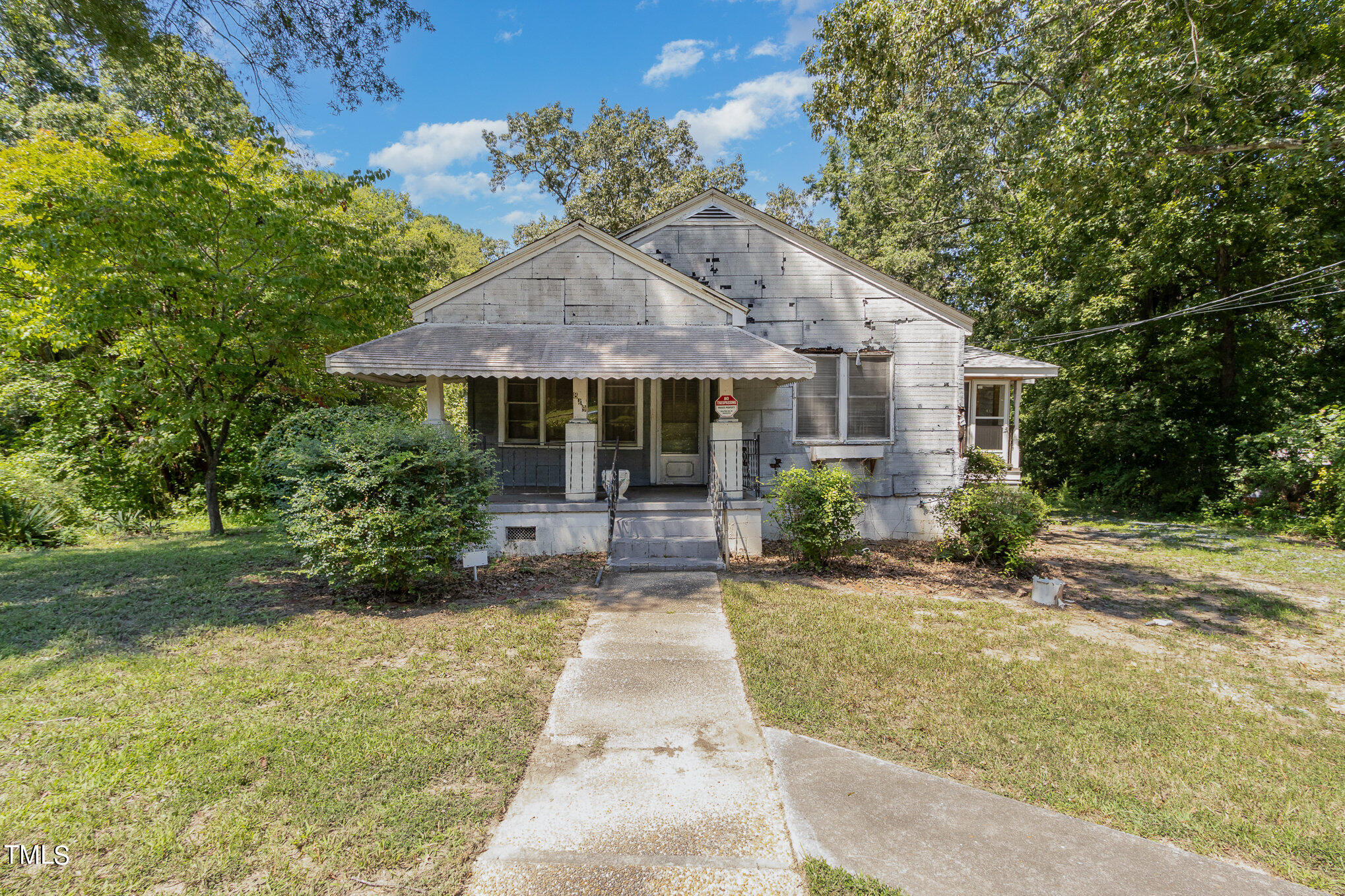 a front view of house with yard and trees around