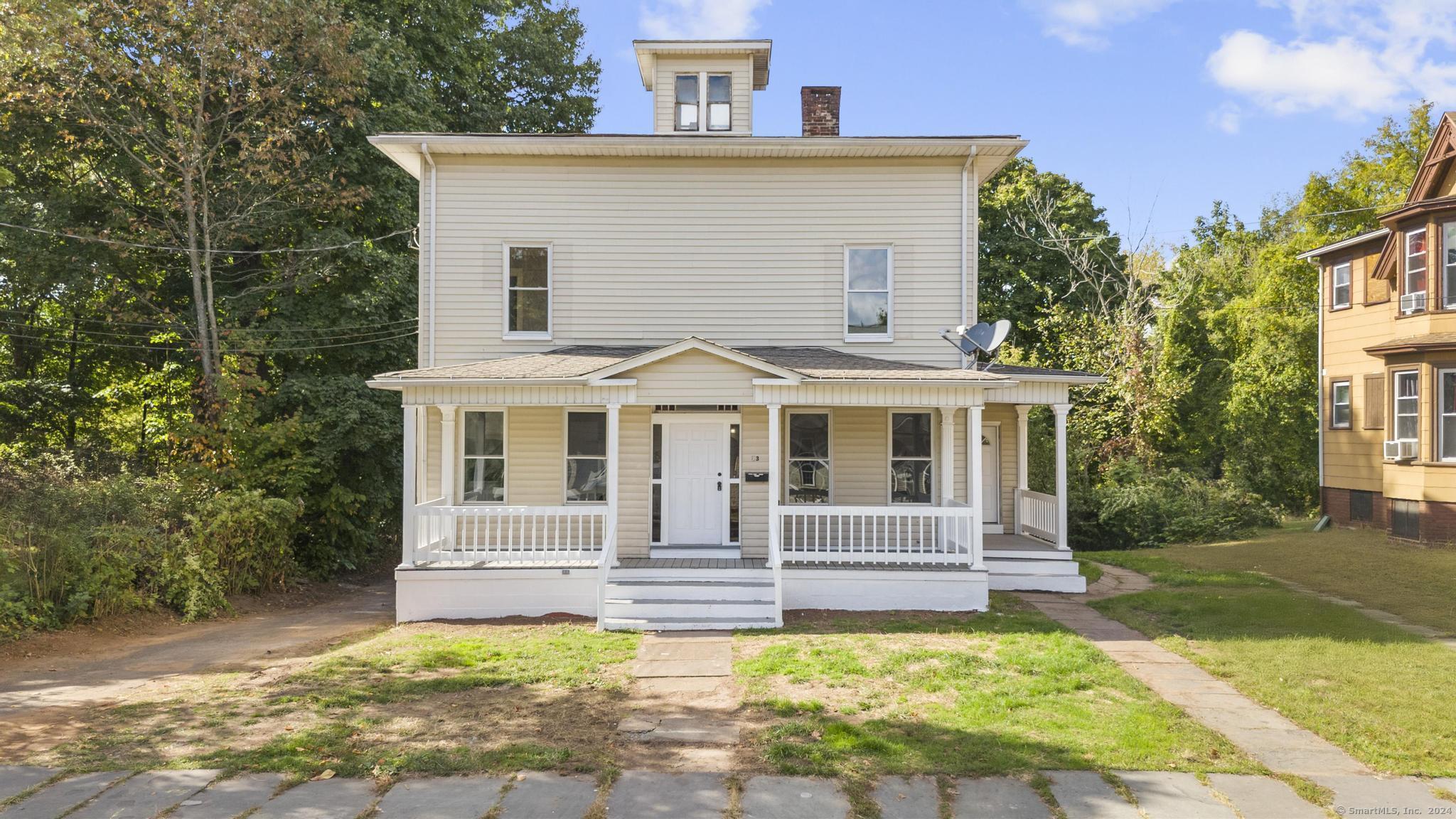 a front view of a house with a yard balcony