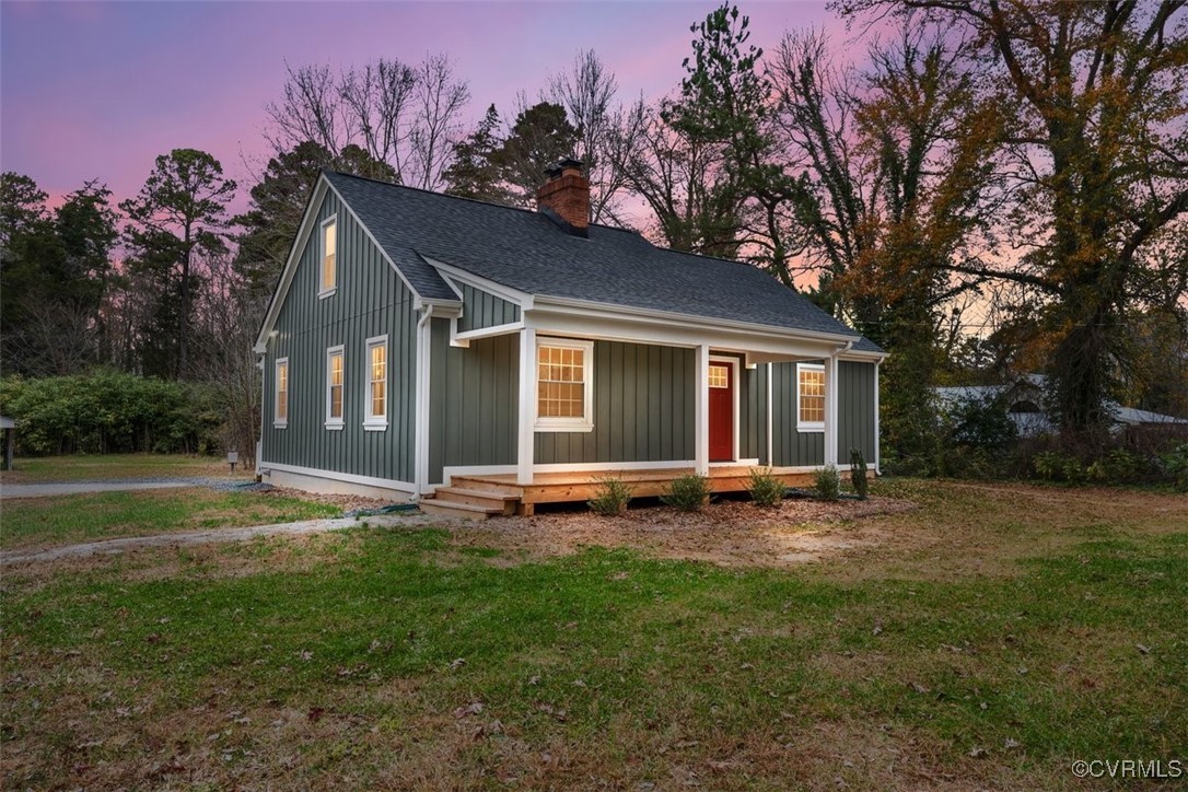 a view of a house with backyard sitting area and garden