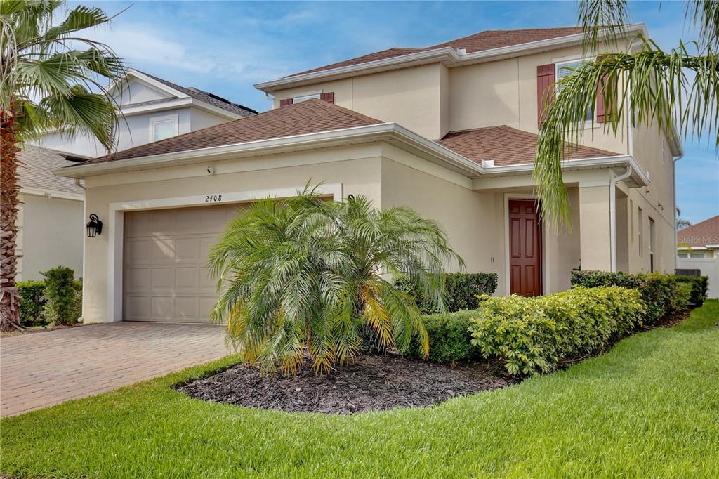 a front view of a house with a garden