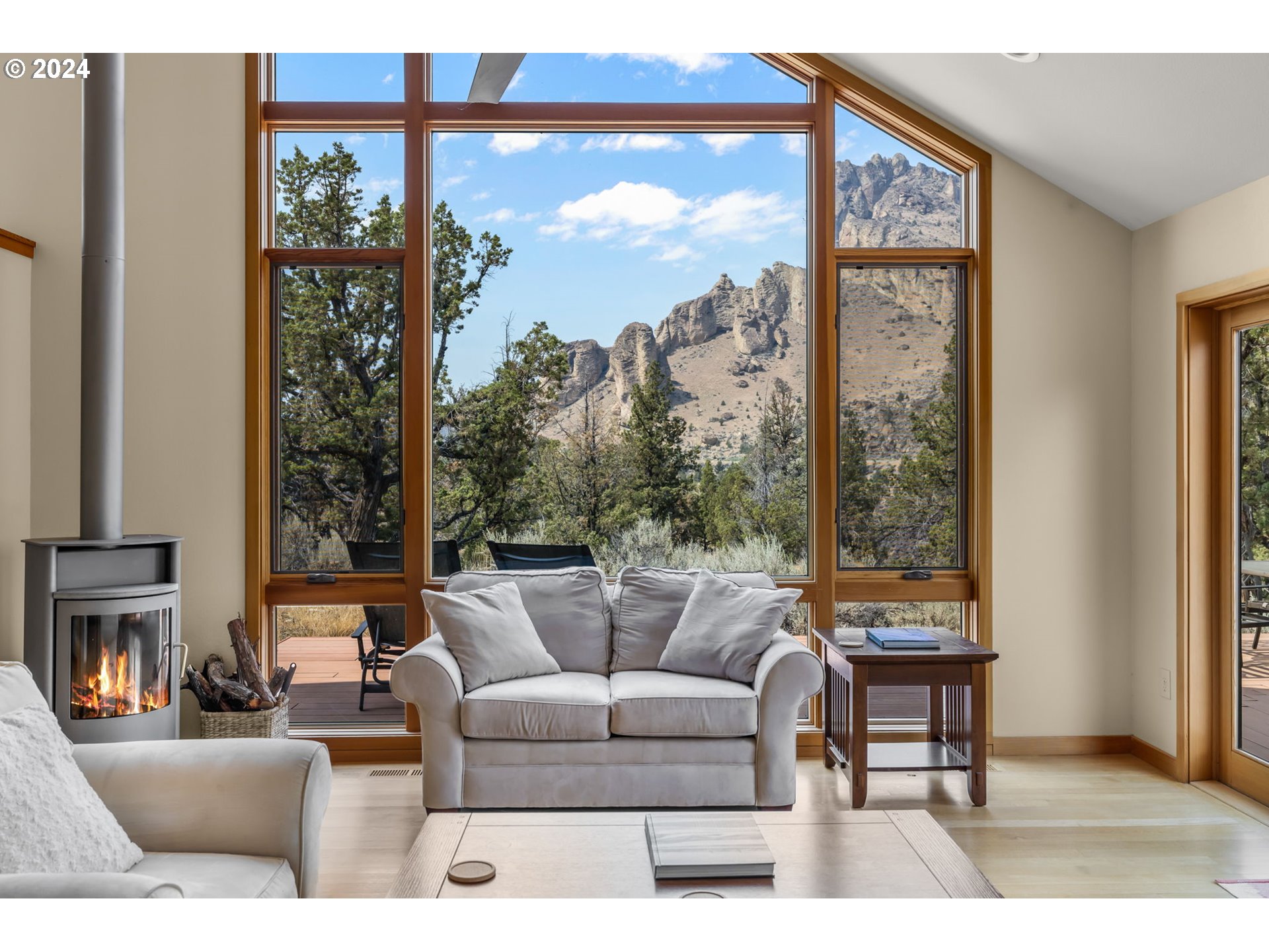 a living room with furniture a large window and a flat screen tv