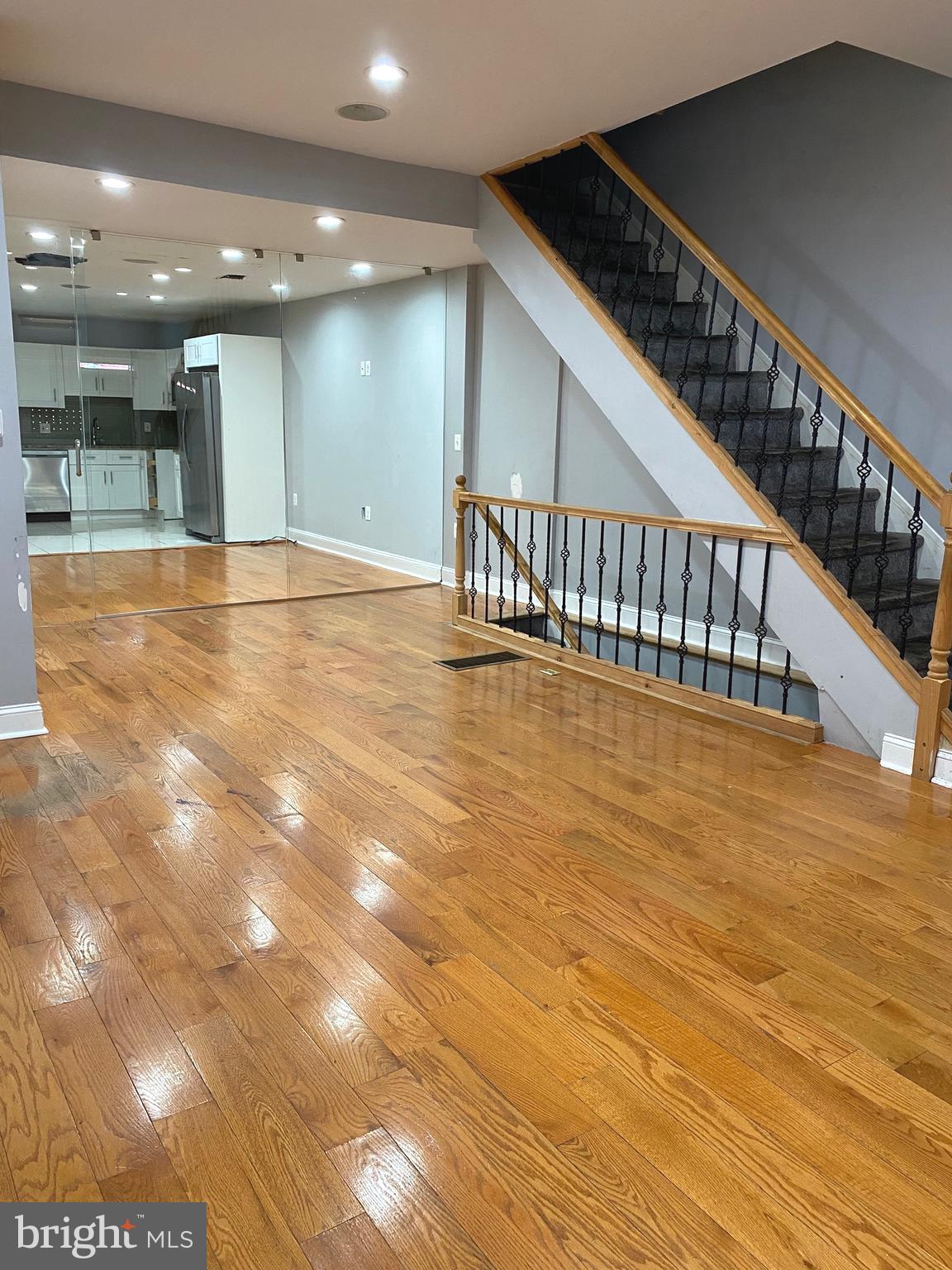 a view of an empty room with wooden floor