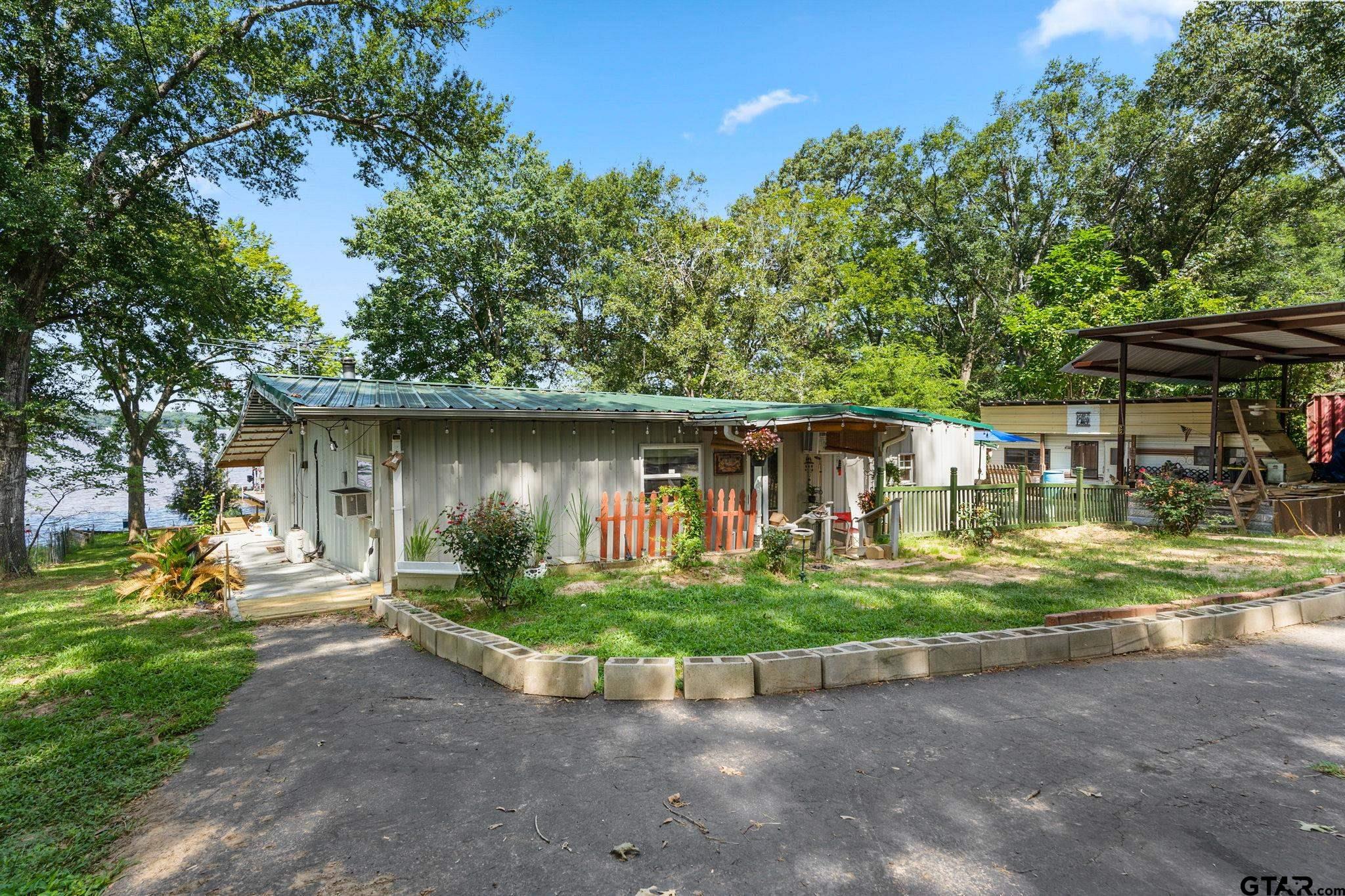 a front view of a house with a yard garage and outdoor seating