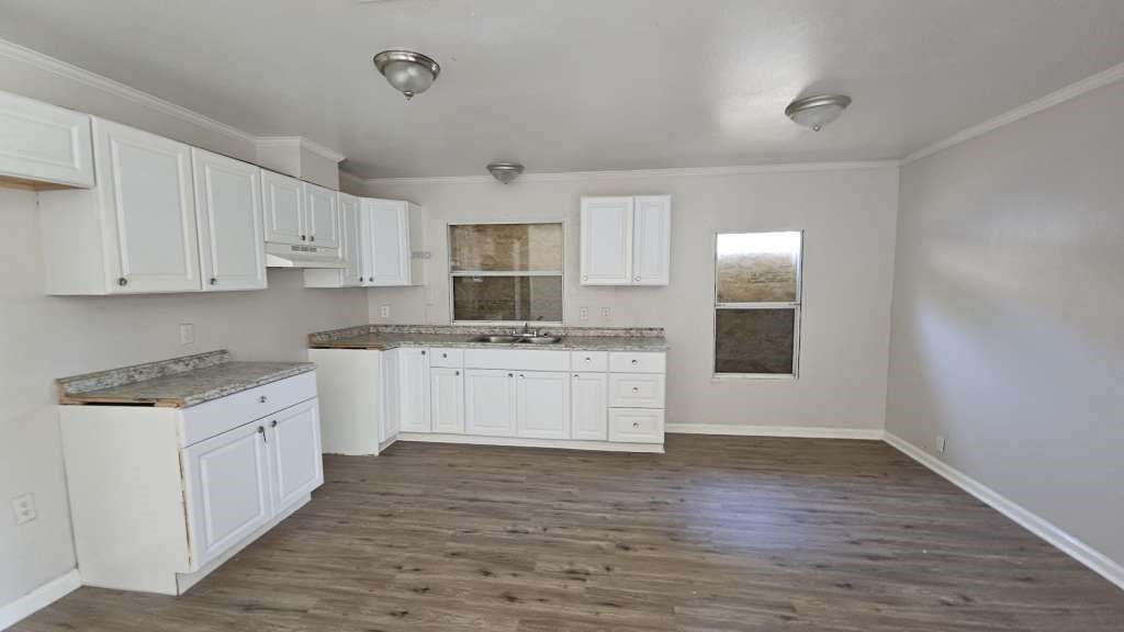 a kitchen with granite countertop white cabinets and white appliances