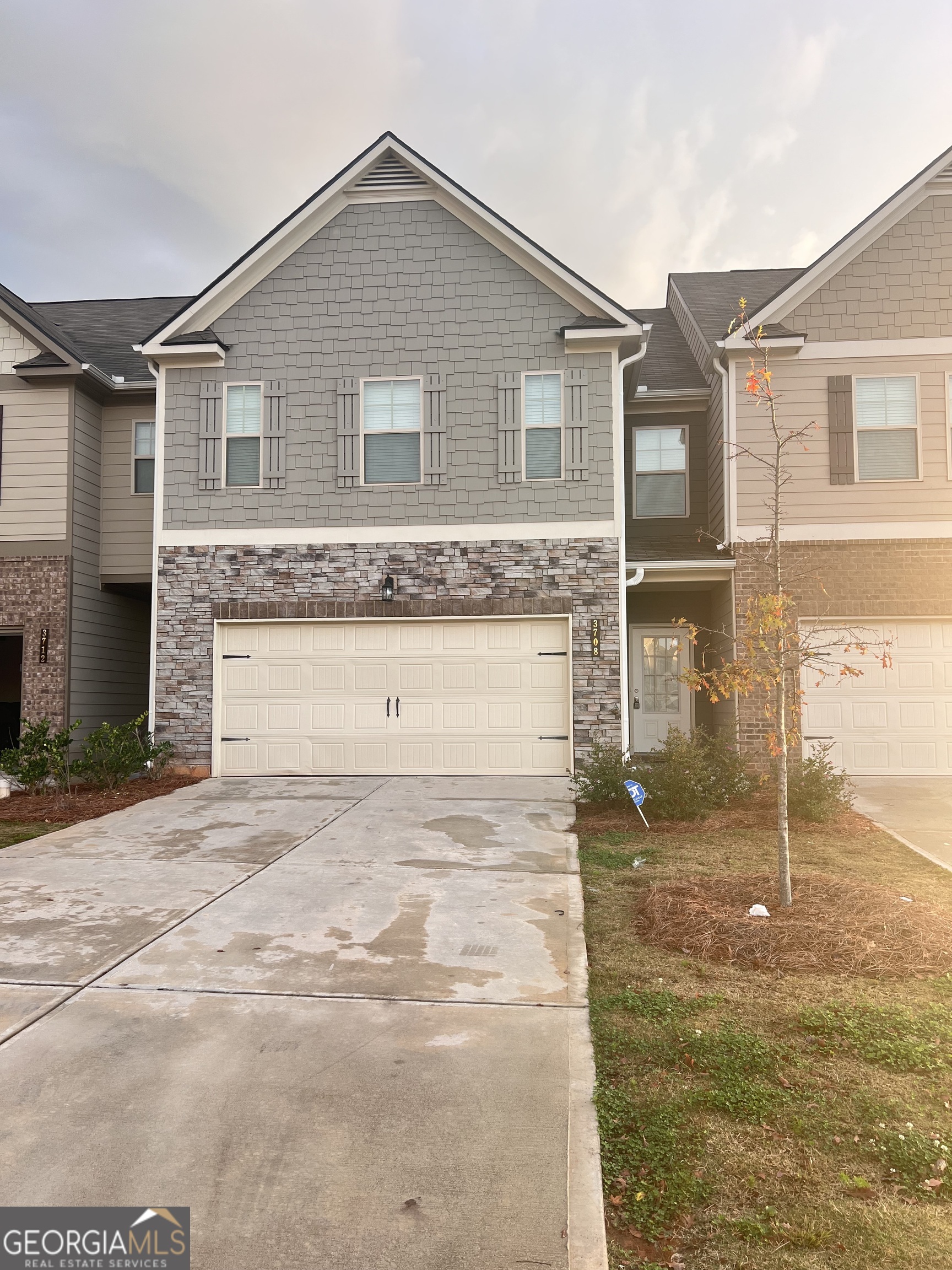 a front view of a house with a yard