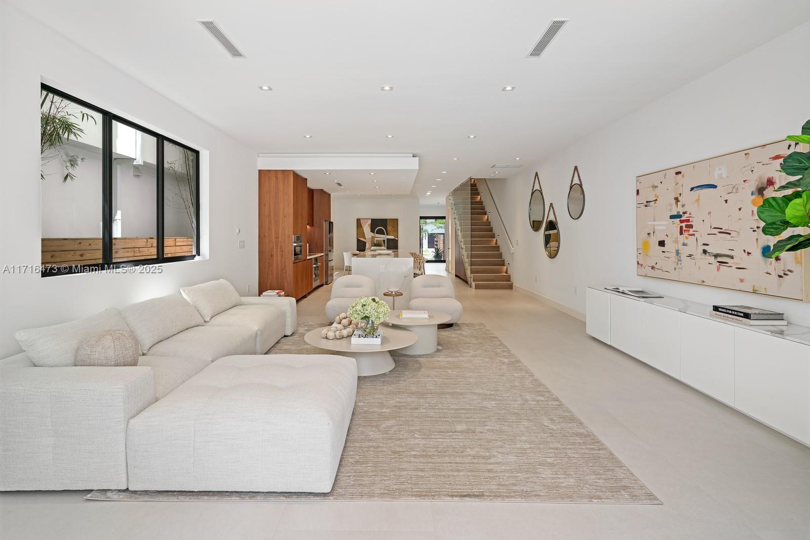 a living room with furniture and painting on the wall