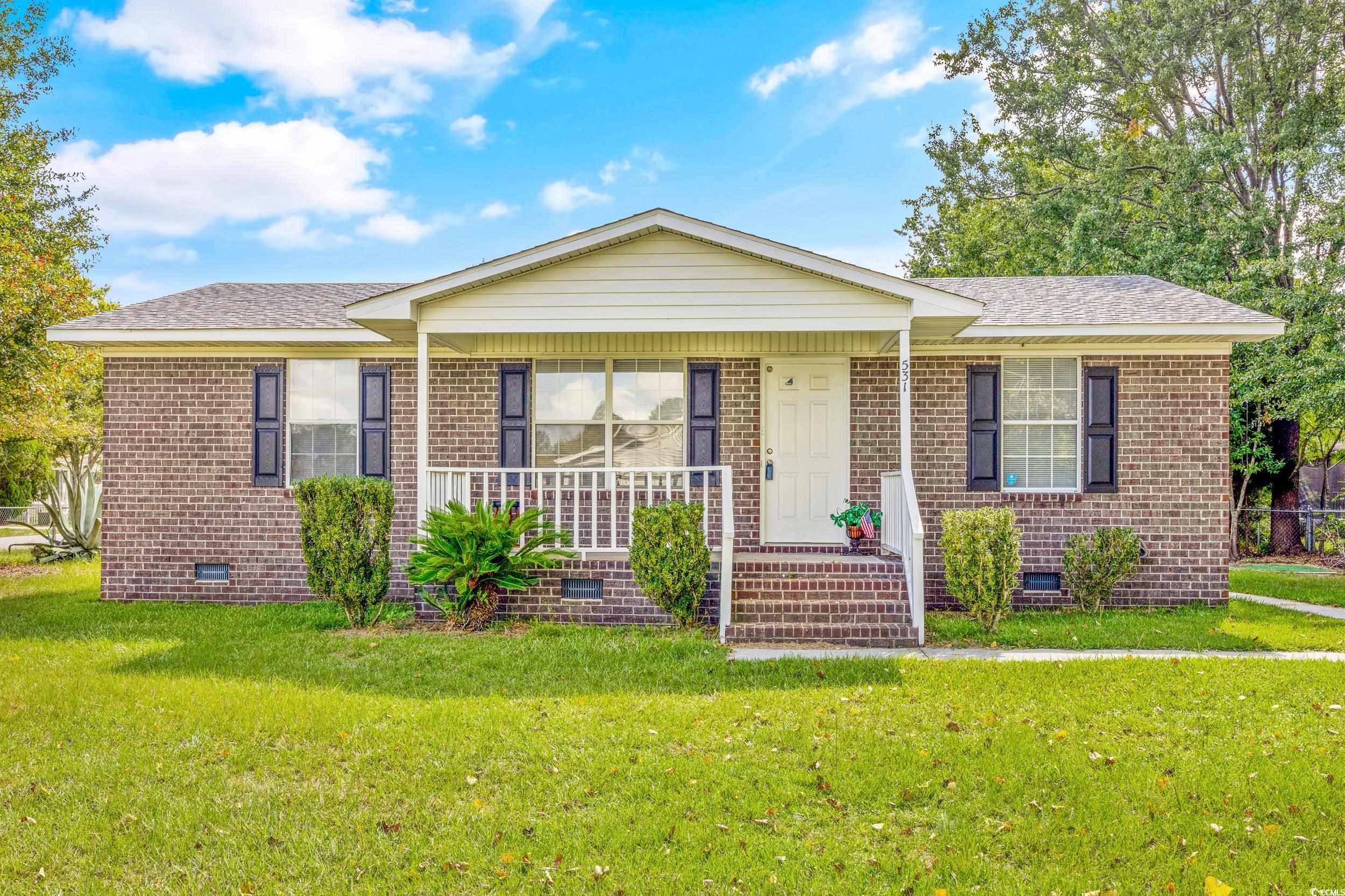 Single story home with a front yard and a porch