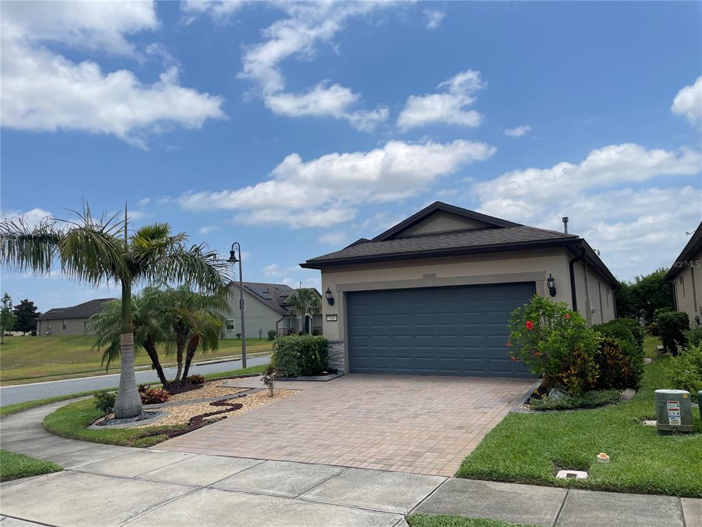 a front view of a house with a yard and garage