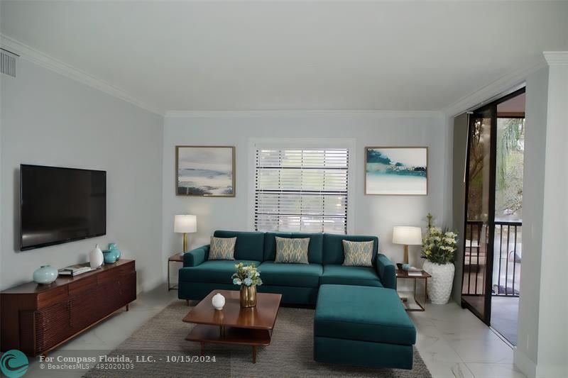 a living room with furniture and a flat screen tv