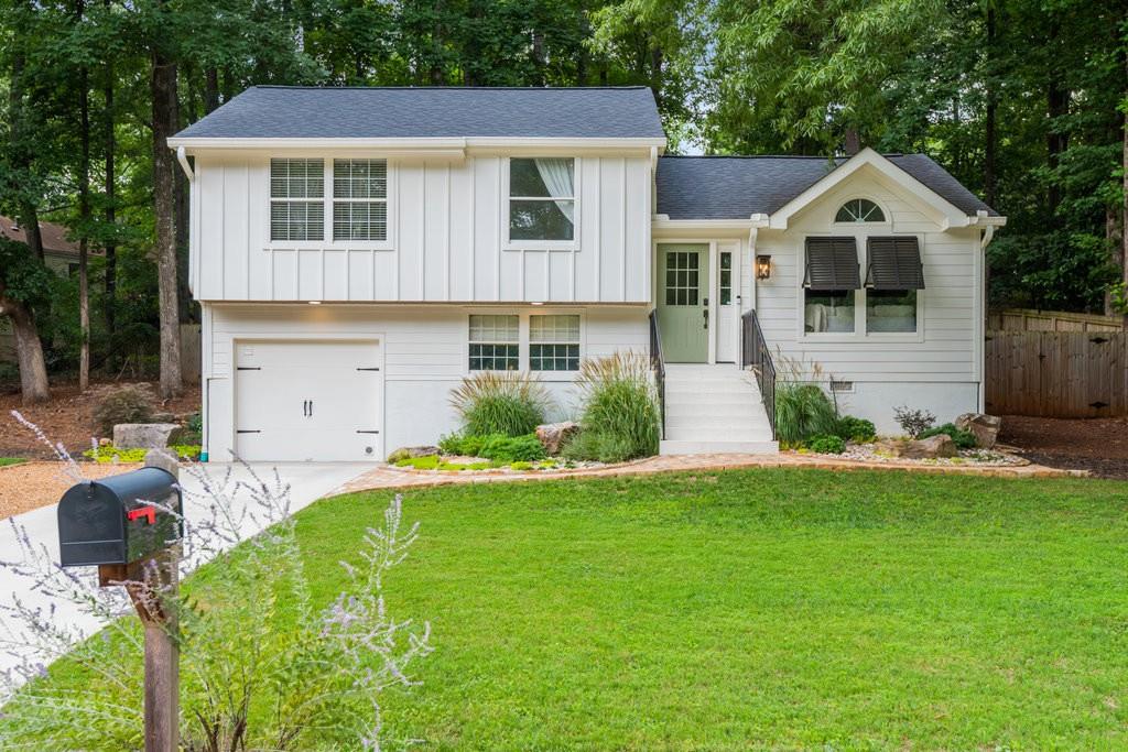 a front view of a house with a yard and garage